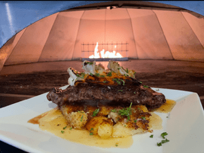 Pan seared NY Strip and jumbo Shrimp. Accompanied by smash potatoes, grilled asparagus, and a zinfandel vinaigrette. 